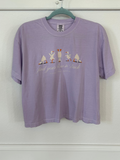 Purple t-shirt with ducks doing yoga and "find your flow in duck" text.