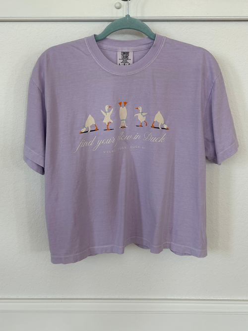Purple t-shirt with ducks doing yoga and "find your flow in duck" text.